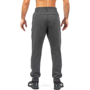 Men's track pants in brushed fleece, featuring a grey colour and a casual fit. Includes a logo on the side.
