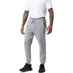 Men's three-layer cotton sandwich pants in grey, featuring a drawstring waist and tapered cuffs. Includes a logo.