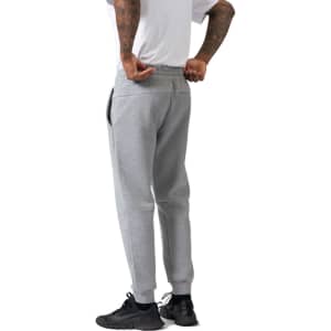 Men's three-layer cotton sandwich pants in grey, featuring a relaxed fit and elasticated waist, with pockets and a logo.