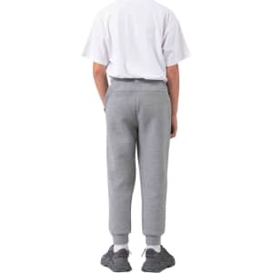 Kids' three-layer track pants in grey, featuring a ribbed cuff and an elastic waistband. Includes branding on the garment.