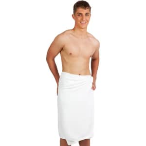 A white bath towel wrapped around a young man standing against a plain background. The man is smiling and shirtless.