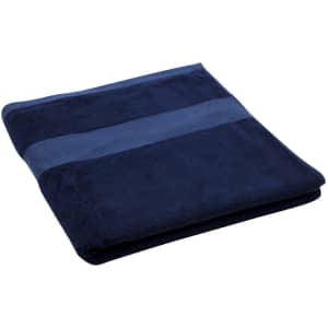 A navy blue bath towel with a textured stripe design, featuring a logo on it.