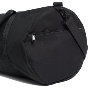 A black duffel bag featuring a zipped pocket and an adjustable strap. The bag has a simple design and branding.
