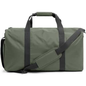 A green duffle bag with black straps and a detachable shoulder strap, featuring a logo.