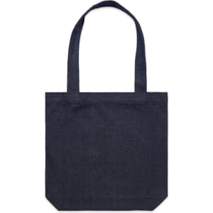 A dark denim tote bag with dual handles and a square bottom. It features a subtle logo on the front.