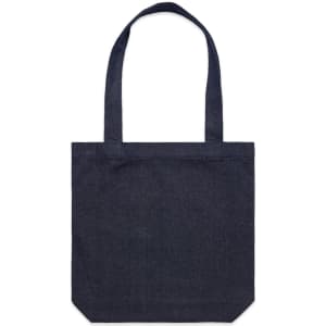 A navy denim tote bag with two handles and a simple square design. It features a logo on the exterior.