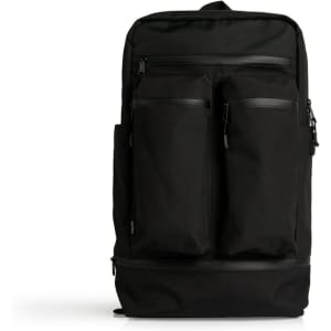 A black recycled travel backpack with multiple zippered compartments and a logo on the front.