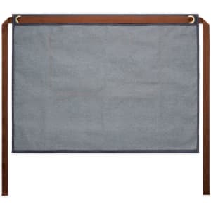 A denim half apron in blue with brown ties, featuring two pockets and a branded logo.