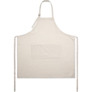 A linen apron in cream with a front pocket, featuring adjustable straps and ties at the sides.
