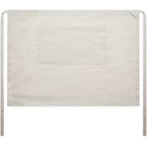 A linen half apron in a light beige colour with ties and a front pocket. The design is simple and functional.