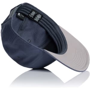 A navy cap with a grey brim, featuring an inner label and a logo. The cap is positioned at an angle.