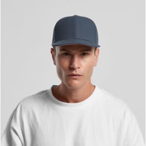 A blue cap with a structured design and a logo, worn by a model in a plain white shirt.
