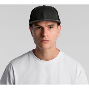 A grey trucker cap with a structured front and mesh back, worn by a model in a white t-shirt.
