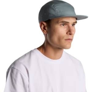 A five-panel cap in light blue worn by a person facing sideways, showcasing its design and fit.