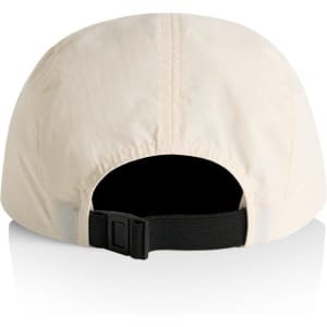 A cream-coloured nylon cap featuring a black adjustable strap and a logo on the back.
