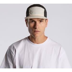 A two-tone nylon cap featuring a light-coloured front panel and a black back, with a logo on the front.
