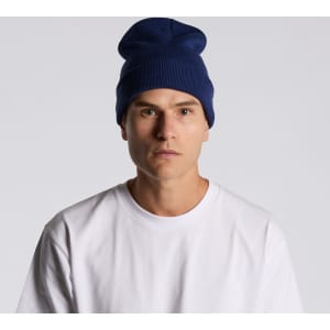A navy cuff beanie worn by a model, featuring a relaxed fit and a simple design.