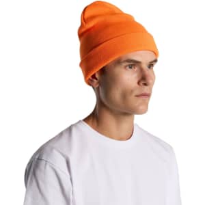 An orange beanie is worn by a model with a neutral expression, paired with a plain white T-shirt.
