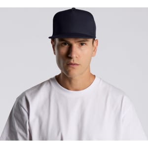 A navy trucker cap featuring a mesh back and a solid front, worn by a person in a white t-shirt.