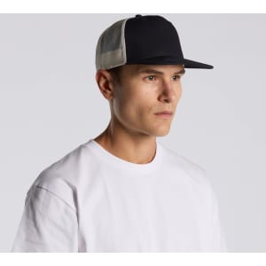 A black and beige trucker cap with a mesh back worn by a male model, featuring a logo.