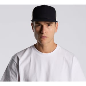 A black and white trucker cap with a logo, worn by a person in a white t-shirt.