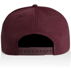 A maroon cap featuring a solid fabric design and an adjustable strap at the back. Includes branding on the side.