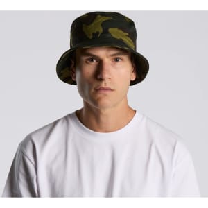 A camo bucket hat in green and black, featuring a wide brim and a fitted design. It includes a branding logo.