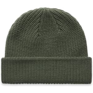A green knitted beanie with a fold-up brim, featuring a logo on the side.