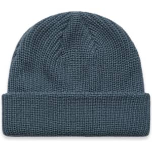 A blue beanie with a textured knit design and a folded cuff. It features a logo on the side.
