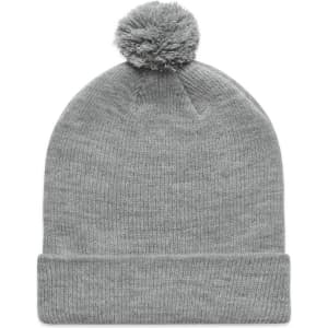 A grey beanie with a pom pom on top, featuring a fold-over cuff and a simple design.