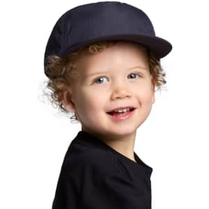 A navy cap designed for kids, featuring a curved brim and a logo on the side, worn by a smiling child.