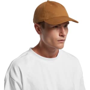 A brown cap with a curved brim and adjustable strap, featuring a logo on the side, worn by a model.