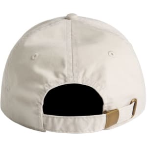 A light beige cap with a back strap and a logo. The design is simple and unstructured.