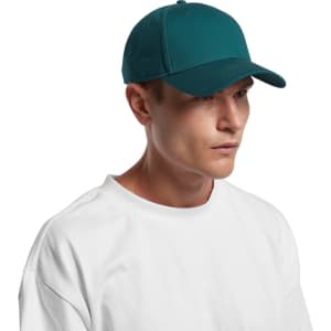 A teal cap worn by a person in a white t-shirt, featuring a logo on the front.