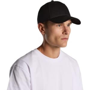 A black cap worn by a model, featuring a curved brim and a fitted design. The model is in a casual white T-shirt.