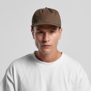 A brown cap with a logo, worn by a person in a white shirt against a plain background.