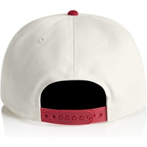 A two-tone cap featuring a cream front and red back, with an adjustable snapback closure and branding.