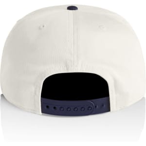 A two-tone cap featuring a cream body and navy peak, with an adjustable snapback closure.