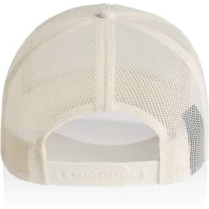 A cream-coloured trucker cap featuring a mesh back and an adjustable strap, with a logo on the side.