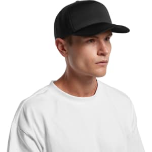 A black foam trucker cap featuring a structured front and mesh panels, worn by a model with a plain white t-shirt.