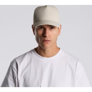 A beige cap made of nylon, featuring a structured design and a logo on the front.