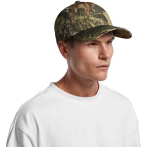 A camo cap featuring a blend of green and brown tones, designed for outdoor wear. It has a logo on the front.
