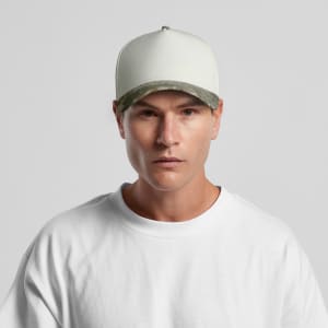 A two-tone camo cap featuring a cream body and a camouflaged brim, worn by a model.