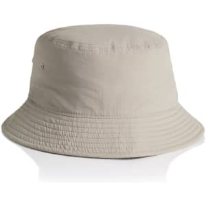 A beige nylon bucket hat with a wide brim and a logo on the side.