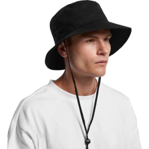 A black wide brim bucket hat with a chin strap, worn by a model in a white T-shirt.