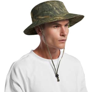 A camo wide-brim bucket hat with a chin strap, featuring shades of green and brown. It has a logo on the side.