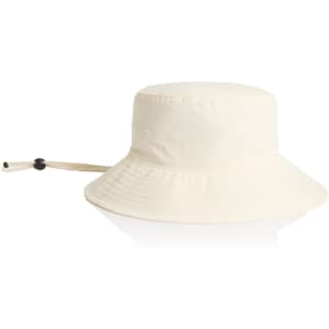 A cream nylon wide brim bucket hat with an adjustable chin strap and a rounded top.