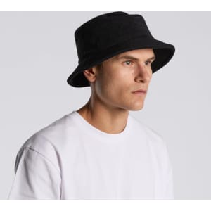 A black Terry Bucket Hat on a model with a plain white T-shirt, featuring a simple design and a logo.