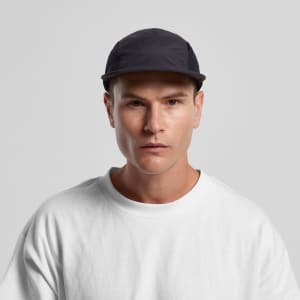 A black cap with a sleek design, featuring a logo and a person wearing a white sweatshirt.