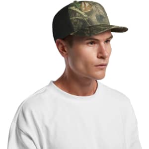 A cap featuring a mesh back and a contrast camo pattern in greens and browns, worn by a model.
